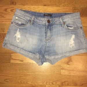 Distressed denim cutoffs